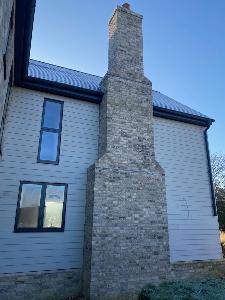 A grand chimney stack at the rear of this new build south of Cambridge.