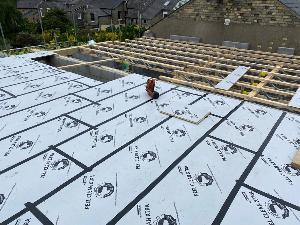 Protected flooring is needed because the roof will take a while to go up at this Cambridge town house new build.