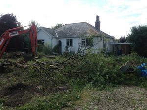 Stripping back brambles and ovegrown bushes for this South Cambridgeshire new build