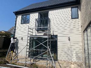 Finishing touches to the weather board cladding on the rear of this new build south of Cambridge.