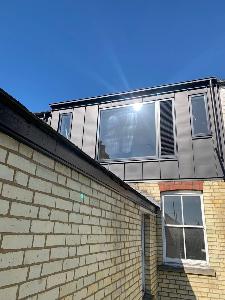 Zinc provides a robust and sleek dormer finish that sits well next to the Cambridge white bricks of this Victorian terrace house refurbishment.